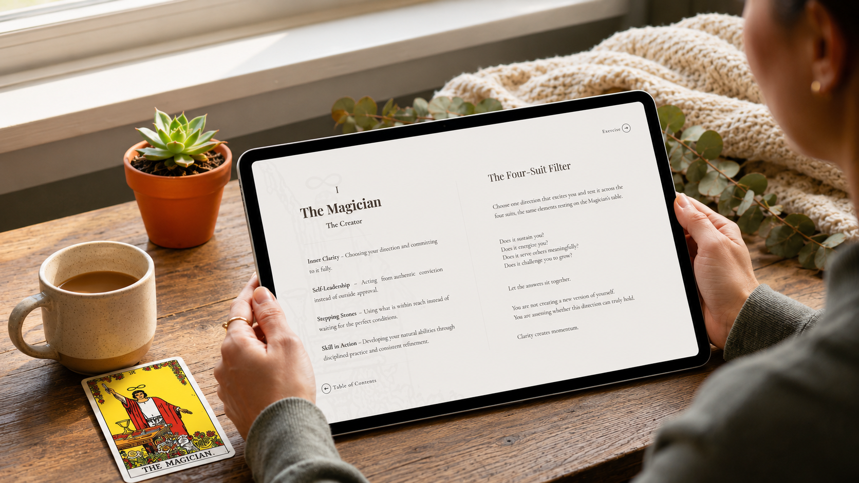 Person using a tablet with tarot card reading on a wooden table. Play Patterns digital workbook – tarot-inspired self-development tool for creatives
